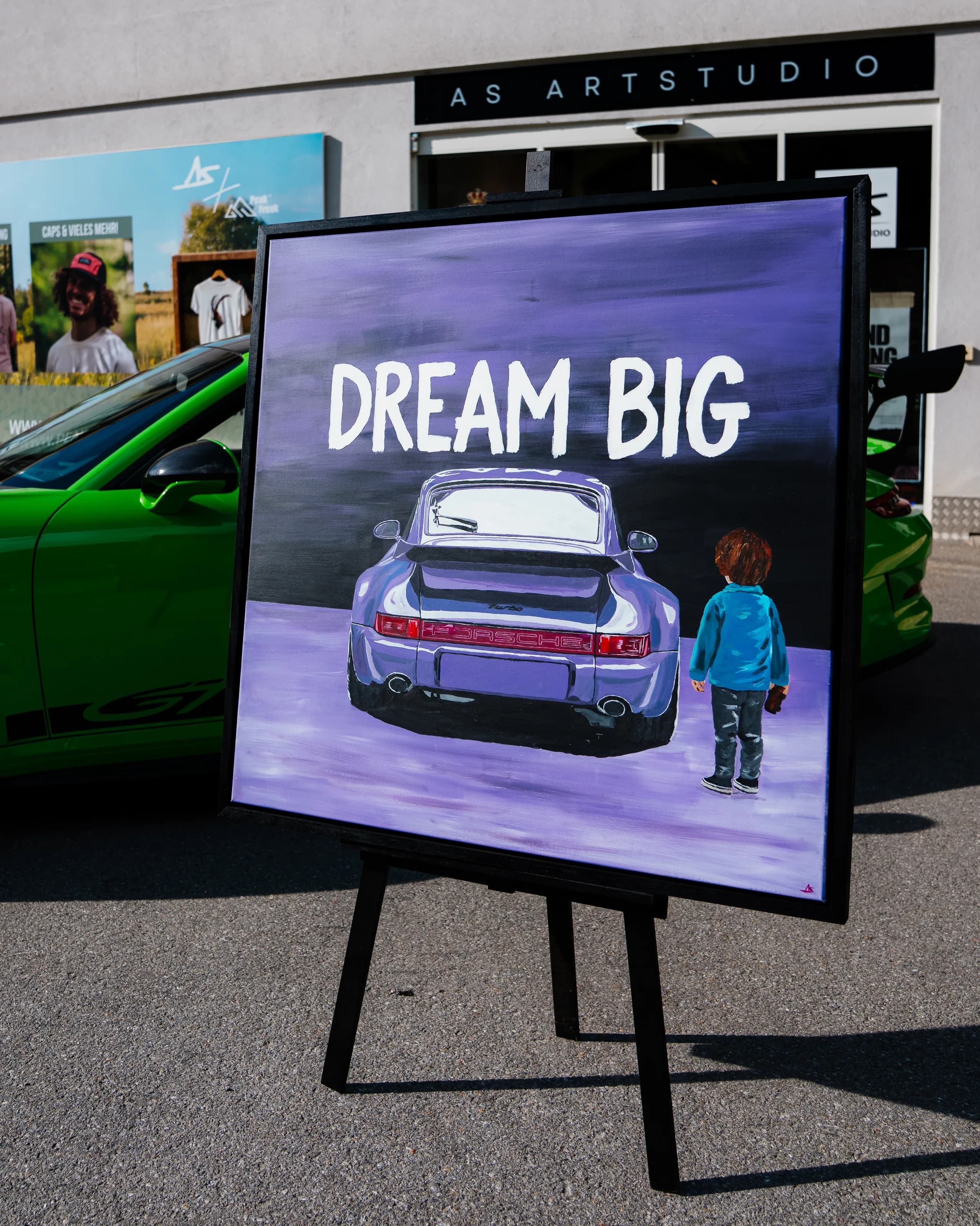The painting “Dream Big”: a Porsche 911 at night in violet light, with a small child looking at it