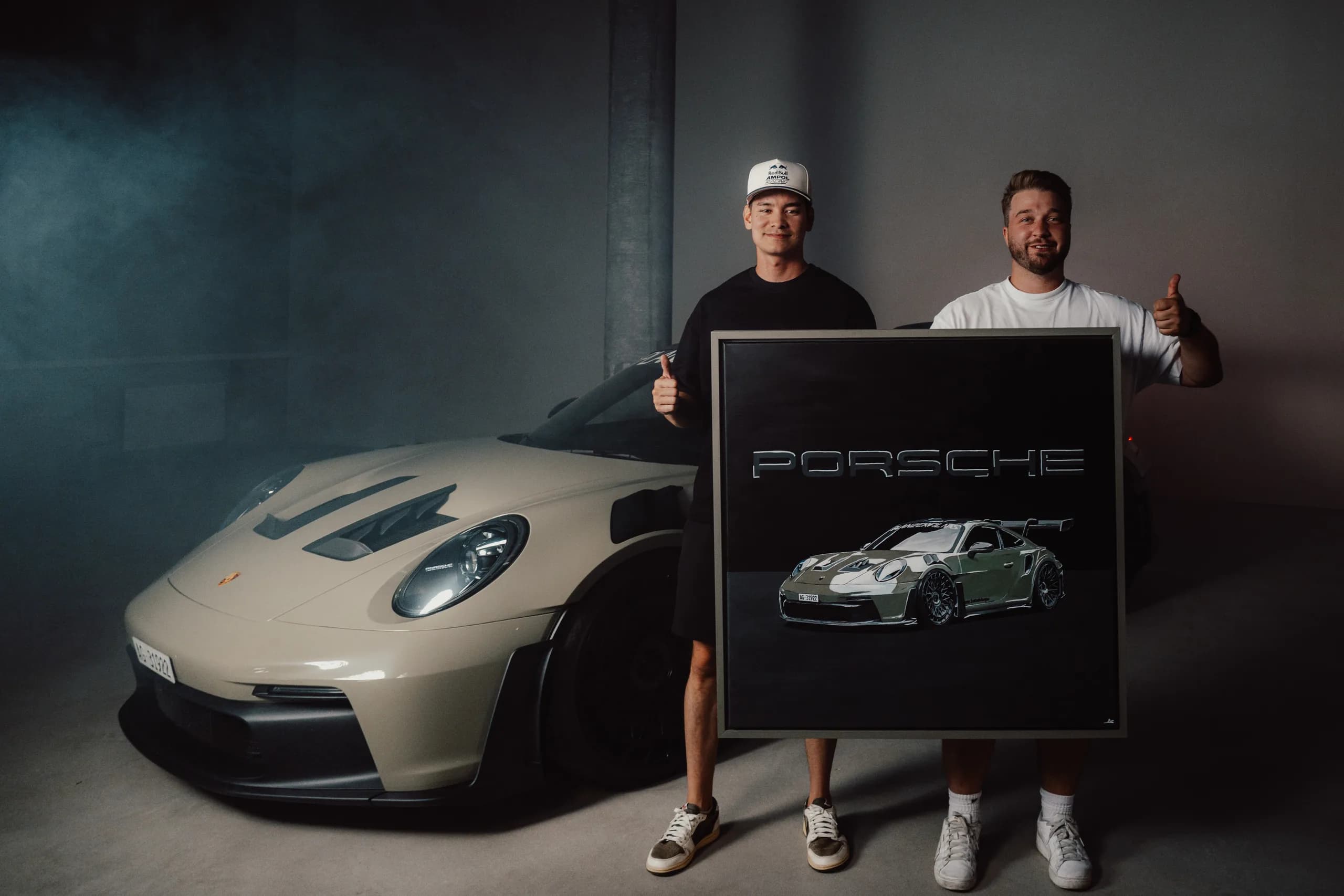 Andre Schwarzhans handing the GT3 RS painting to its owner in front of the car
