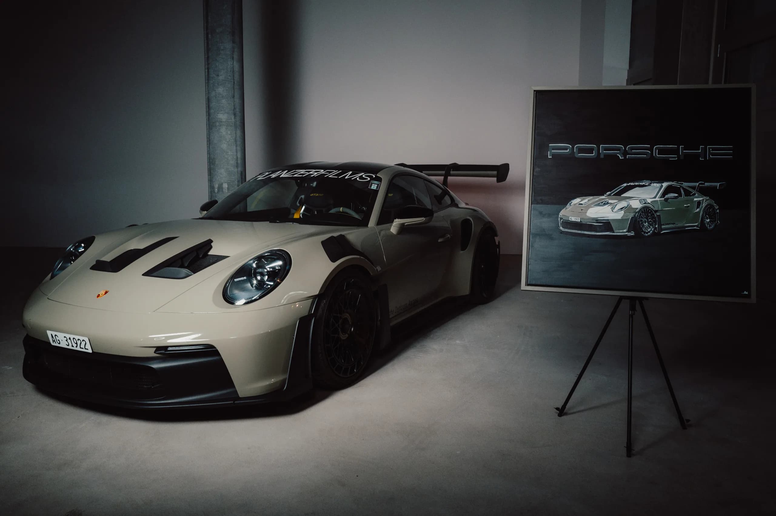 The GT3 RS painting and the car together in the darkened studio