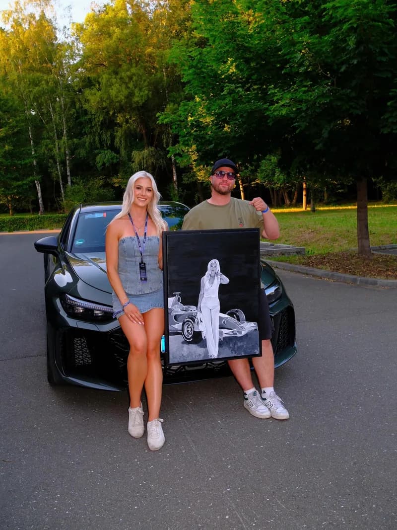 Laura Sommer and Andre Schwarzhans with the finished painting in front of an Audi RS 6