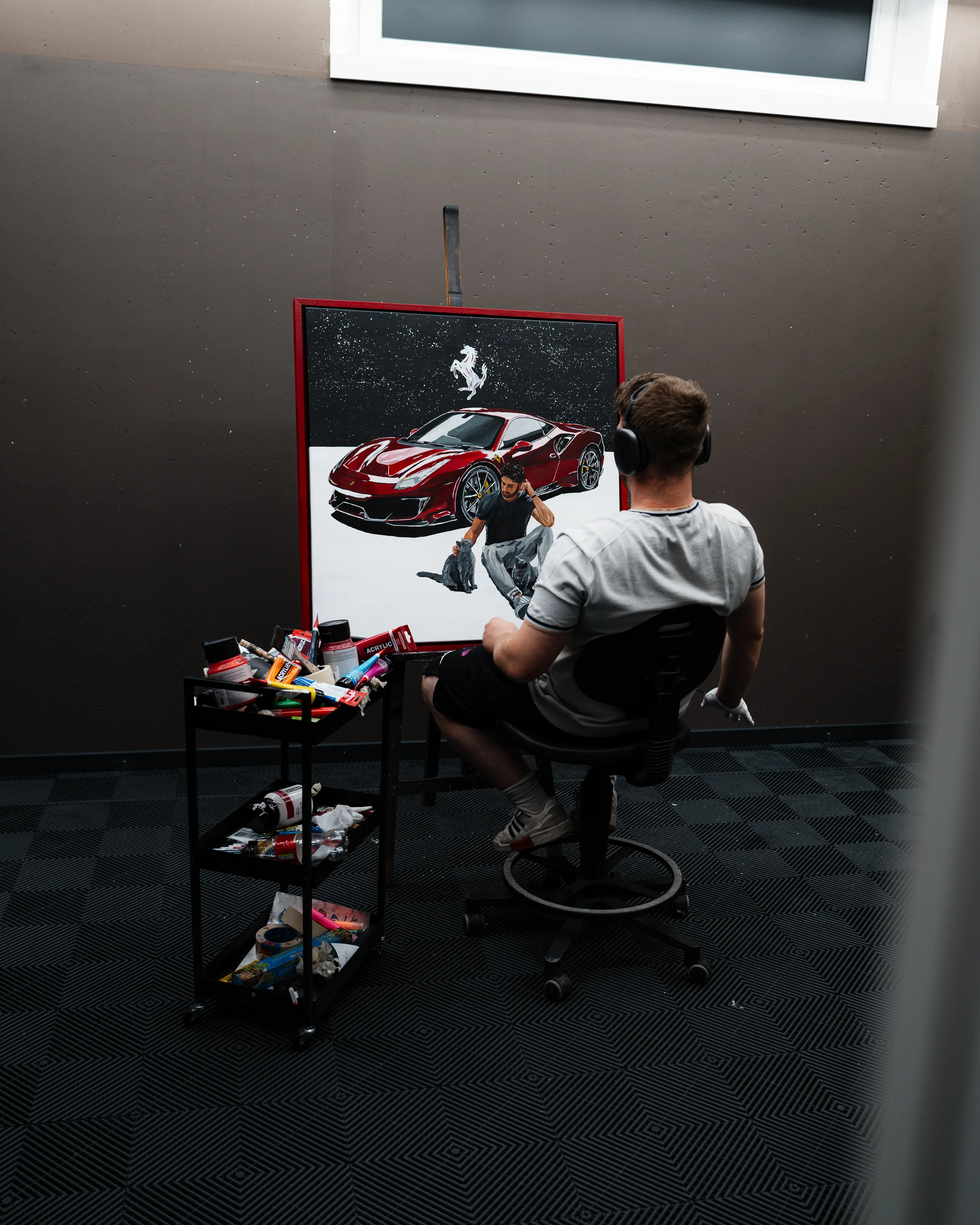 Andre Schwarzhans painting the Eligella Ferrari 488 Pista canvas in the studio