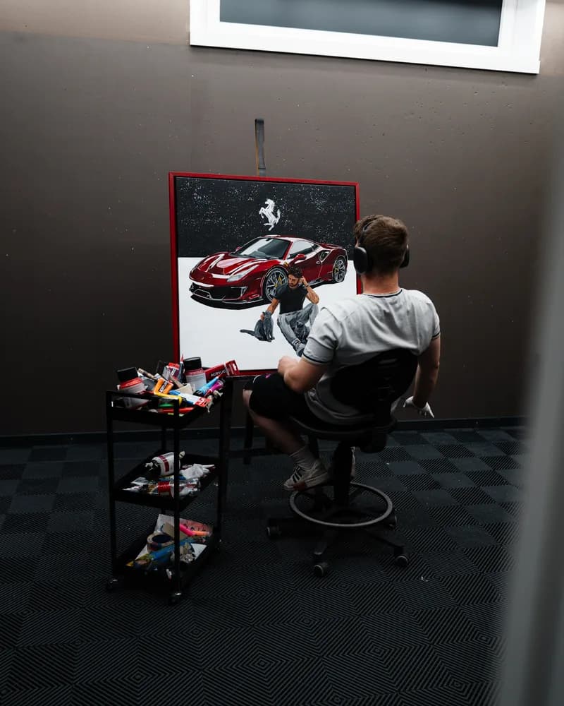 Andre Schwarzhans painting the Eligella Ferrari 488 Pista canvas in the studio