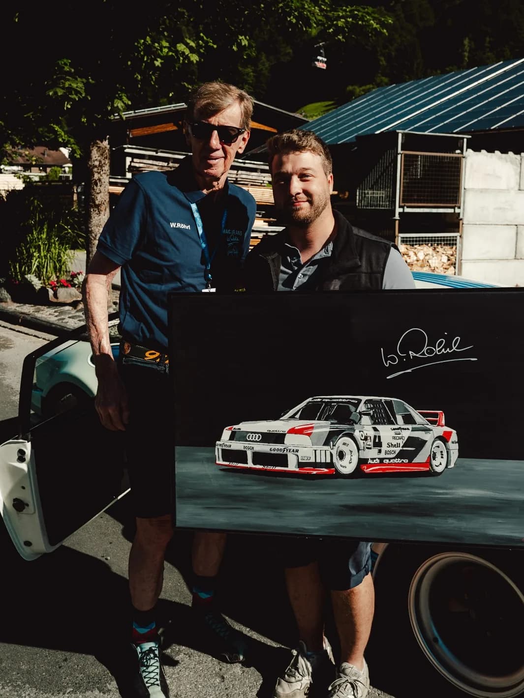 Andre Schwarzhans and Walter Röhrl with the signed Audi 90 quattro IMSA painting