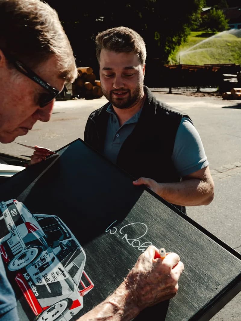 Walter Röhrl signing the Audi 90 quattro IMSA painting